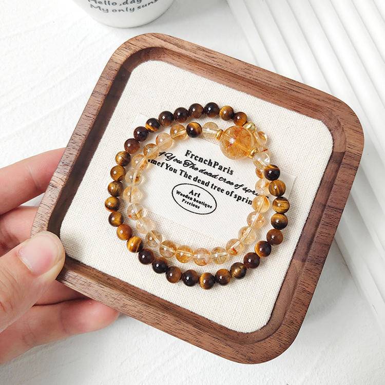 Multi-gem bracelet with tiger eye and citrine tower designed to enhance protection and positive energy.