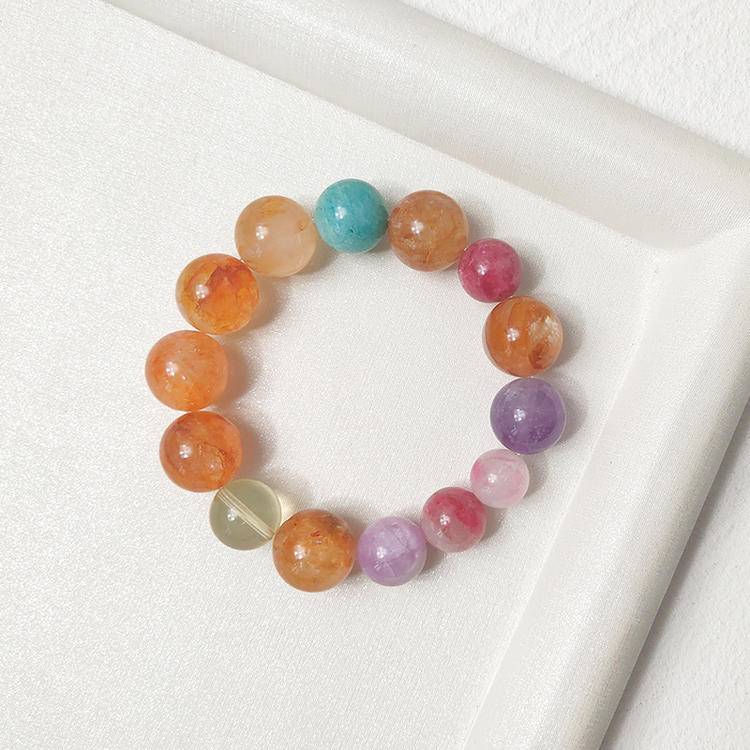 Healing multi-gemstone bracelet in yellow jade flower, citrine, and aquamarine, featuring rhodochrosite and lepidolite for emotional well-being and energy balance.
