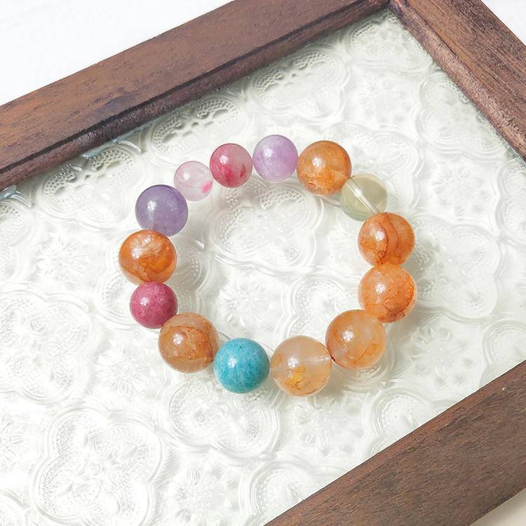Yellow jade flower and citrine bracelet with aquamarine, lepidolite, and rhodochrosite, promoting positive energy, balance, and emotional health.

