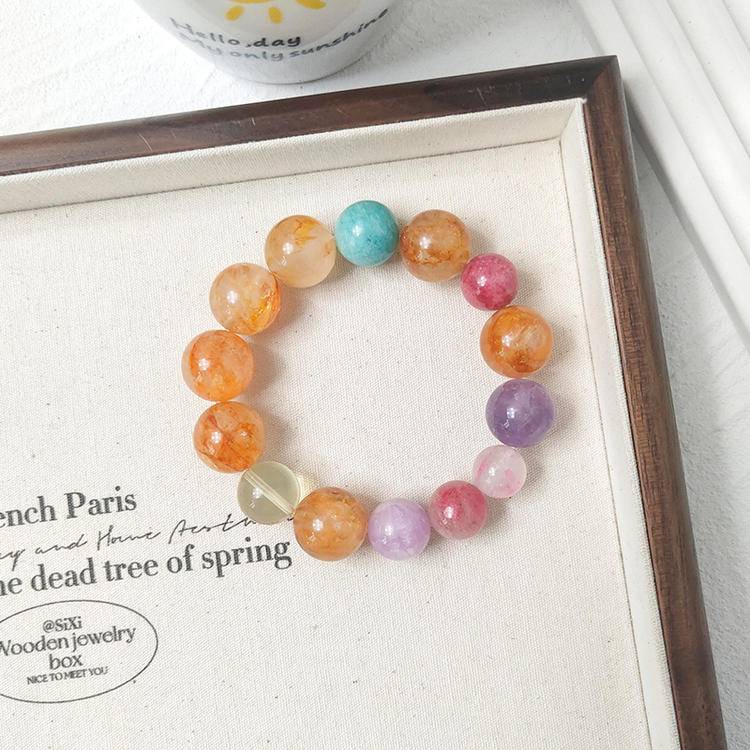 Healing multi-gemstone bracelet featuring yellow jade flower, citrine, aquamarine, lepidolite, and rhodochrosite, designed for emotional balance and positive energy.
